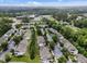 Aerial view of a neighborhood with townhomes, landscaping, parking, and a school nearby at 214 Cedar Elm Rd, Durham, NC 27713