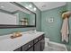 Well-lit bathroom featuring a modern vanity, framed mirror, and stylish accents at 214 Cedar Elm Rd, Durham, NC 27713