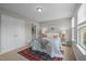 Cozy bedroom with plush carpet, ample natural light, and a view of the ensuite bathroom at 214 Cedar Elm Rd, Durham, NC 27713