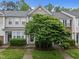 Charming townhouse exterior with well-maintained landscaping and a lush green tree in the front at 214 Cedar Elm Rd, Durham, NC 27713