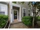 Inviting front entrance with stylish wreath, green bushes, and well-kept walkway at 214 Cedar Elm Rd, Durham, NC 27713