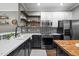 Updated kitchen boasts stainless steel appliances, floating shelves, and ample counter space at 214 Cedar Elm Rd, Durham, NC 27713