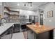 Bright kitchen featuring stainless steel appliances, a kitchen island, and modern fixtures at 214 Cedar Elm Rd, Durham, NC 27713