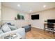 Finished basement living area with comfortable seating, a workspace, and natural light at 2216 Lawrence Dr, Raleigh, NC 27603