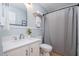 Cozy bathroom with updated vanity, stainless steel fixtures, and a shower with gray curtain at 2216 Lawrence Dr, Raleigh, NC 27603