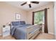 Comfortable bedroom with a ceiling fan and natural light from the backyard view at 2216 Lawrence Dr, Raleigh, NC 27603