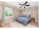 Relaxing bedroom with a ceiling fan, window views, and neutral colors, creating a peaceful retreat at 2216 Lawrence Dr, Raleigh, NC 27603