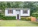 Charming two-story home with light blue siding, black shutters, and landscaped front yard at 2216 Lawrence Dr, Raleigh, NC 27603