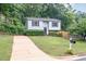 Well-maintained two-story home with light blue siding, a long driveway, and a green lawn at 2216 Lawrence Dr, Raleigh, NC 27603