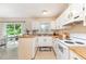 Functional kitchen features bright lighting, white appliances, and a breakfast bar for casual dining at 2216 Lawrence Dr, Raleigh, NC 27603