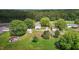 Aerial view of the property showcasing the house, surrounding trees, and outbuildings at 2227 Us-15, Creedmoor, NC 27522