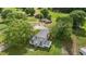 Aerial view of the home featuring a metal roof and several outbuildings on a large, green lot at 2227 Us-15, Creedmoor, NC 27522