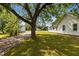 Expansive backyard featuring a mature tree, lush green lawn, and additional outbuildings at 2227 Us-15, Creedmoor, NC 27522