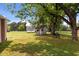 Backyard has storage building, old playhouse, mature trees and shade at 2227 Us-15, Creedmoor, NC 27522