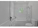 Bright white bathroom featuring subway tile and shower and tub combination at 2227 Us-15, Creedmoor, NC 27522