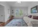 Bright bedroom features hardwood floors, area rug, and natural light at 2227 Us-15, Creedmoor, NC 27522