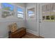 Bright entryway with windows, an exterior door, hardwood floors, and a wooden chest at 2227 Us-15, Creedmoor, NC 27522