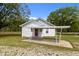 Charming single-story home with white siding, a vibrant red door, and a convenient carport at 2227 Us-15, Creedmoor, NC 27522