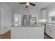 Kitchen island with granite countertop, stainless refrigerator and white cabinetry at 2227 Us-15, Creedmoor, NC 27522
