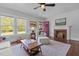 Cozy living room featuring a fireplace, hardwood floors, and ample natural light at 2227 Us-15, Creedmoor, NC 27522