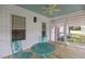 Screened in porch with wood flooring, metal table and chairs, and ceiling fan at 2227 Us-15, Creedmoor, NC 27522