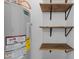 Utility room features modern water heater and floating wood shelves at 2227 Us-15, Creedmoor, NC 27522