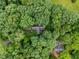 Drone shot of a home surrounded by mature, dense trees creating a private and natural setting at 224 Crawford Rd, Hillsborough, NC 27278