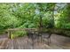Enjoy the great outdoors on this back deck featuring wooded scenery, and a table with chairs at 224 Crawford Rd, Hillsborough, NC 27278