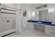 Clean bathroom featuring a shower-tub combination and a bright blue vanity at 224 Crawford Rd, Hillsborough, NC 27278
