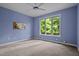 Comfortable bedroom with large window, ceiling fan and light blue walls at 224 Crawford Rd, Hillsborough, NC 27278