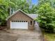 Traditional brick home with attached two-car garage, showcasing a well-maintained exterior at 224 Crawford Rd, Hillsborough, NC 27278