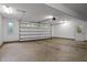 Spacious two car garage featuring two doors, lighting, and an easy to clean concrete floor at 224 Crawford Rd, Hillsborough, NC 27278