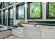 Convenient kitchen sink area featuring updated appliances, lighting, and green trim at 224 Crawford Rd, Hillsborough, NC 27278