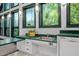 The kitchen features a practical sink area with natural light and green trim at 224 Crawford Rd, Hillsborough, NC 27278