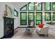 Sun-filled living room with fireplace and large windows showcasing the lush greenery outside at 224 Crawford Rd, Hillsborough, NC 27278