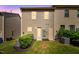 Backyard featuring green lawn and small bushes against the townhouse at 246 Spark St, Raleigh, NC 27606