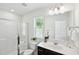 Bright bathroom featuring a glass-enclosed shower and a large vanity with a mirror at 246 Spark St, Raleigh, NC 27606