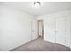 Neutral carpeted bedroom with two doors and overhead lighting at 246 Spark St, Raleigh, NC 27606