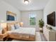 Well-lit bedroom with stylish decor, and a view of the neighborhood at 246 Spark St, Raleigh, NC 27606