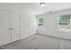Comfortable bedroom with neutral carpet, closet space, and large windows at 246 Spark St, Raleigh, NC 27606