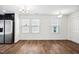 Open dining area with wood floors, modern lighting, and stainless steel refrigerator at 246 Spark St, Raleigh, NC 27606