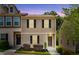 Inviting two-story townhome featuring neutral siding, dark shutters, and well-maintained landscaping at 246 Spark St, Raleigh, NC 27606