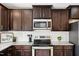 Updated kitchen featuring stainless steel appliances, granite counters, and dark cabinets at 246 Spark St, Raleigh, NC 27606