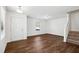 Bright living room featuring wood floors, a front door, and a staircase at 246 Spark St, Raleigh, NC 27606