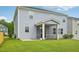 View of the home's spacious backyard and screened porch with ceiling fan, perfect for outdoor entertaining at 256 Summer Ranch Dr, Fuquay Varina, NC 27526