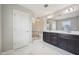 Primary bathroom features marble tile, glass shower, double vanity with dark cabinets at 256 Summer Ranch Dr, Fuquay Varina, NC 27526