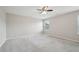 Empty bedroom with neutral gray carpet, ceiling fan, and a window at 256 Summer Ranch Dr, Fuquay Varina, NC 27526