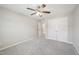Bedroom featuring plush carpeting, a ceiling fan, and closet with double doors at 256 Summer Ranch Dr, Fuquay Varina, NC 27526