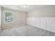 Bedroom featuring plush carpeting, board and batten trim, and a window with natural light at 256 Summer Ranch Dr, Fuquay Varina, NC 27526