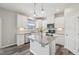 Modern kitchen features an island, granite countertops, and stainless steel appliances at 256 Summer Ranch Dr, Fuquay Varina, NC 27526